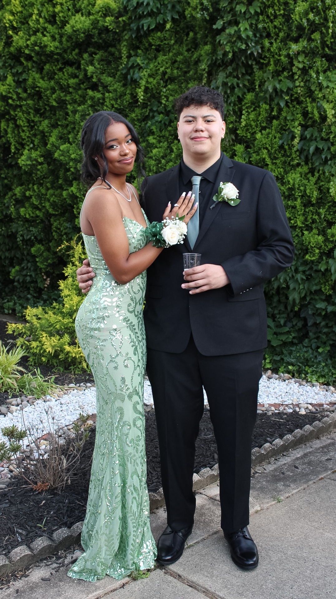 Elegant prom couple in green sequin gown
